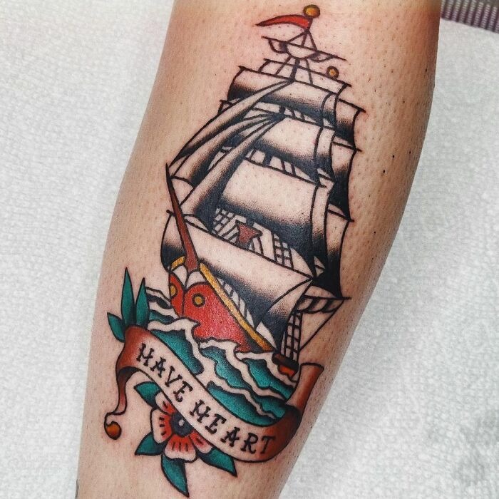 American traditional tattoo of a sailing ship with a "Have Heart" banner on forearm.
