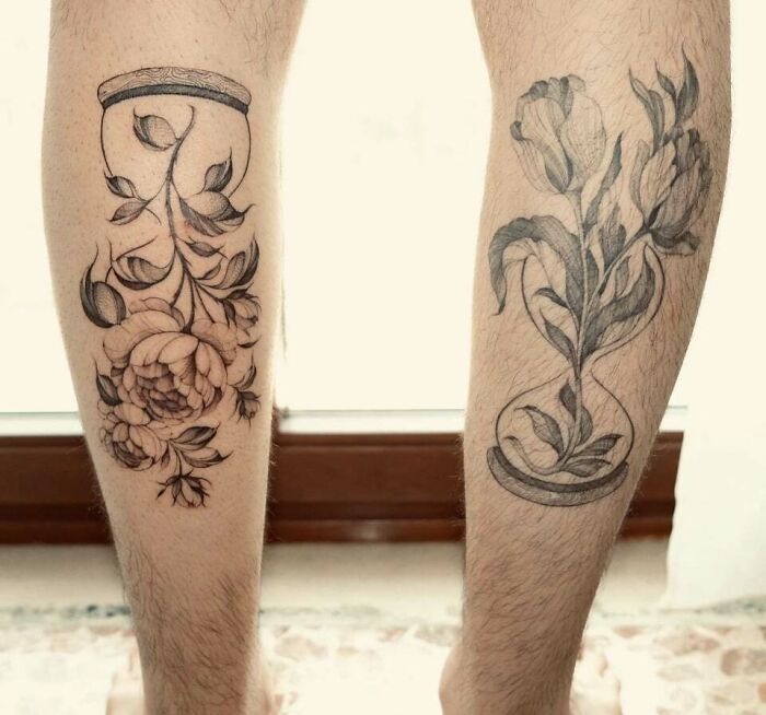 Legs adorned with intricate flower tattoos, showcasing blossoms in hourglass designs.