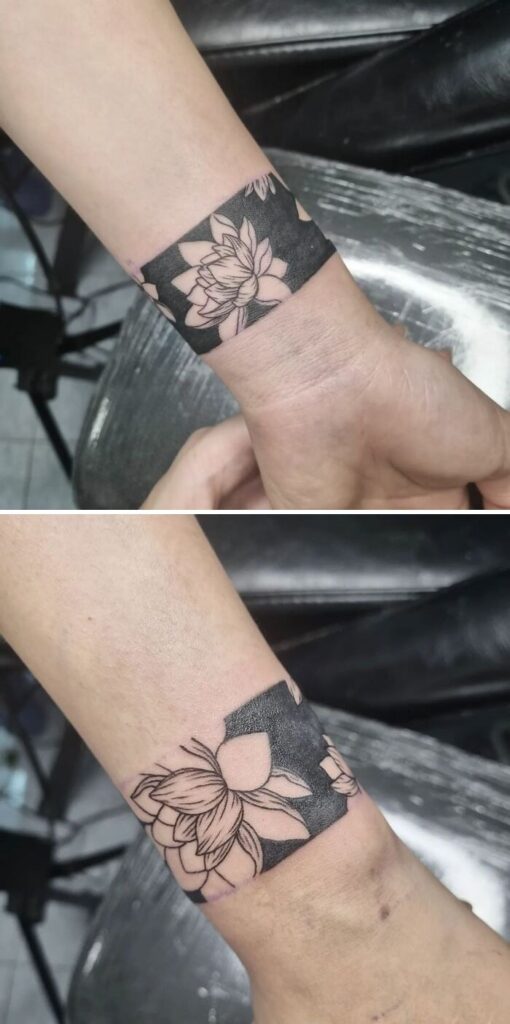 Flower tattoo on wrist blending intricate petal designs with dark background, creating a blooming effect on the skin.