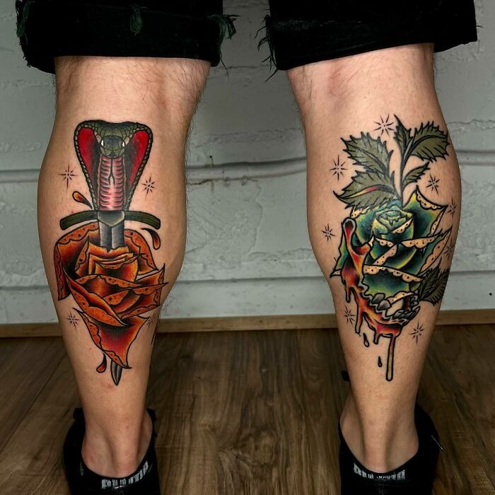Unique flower tattoos on calves, featuring vivid rose designs with a dagger and snake motif.